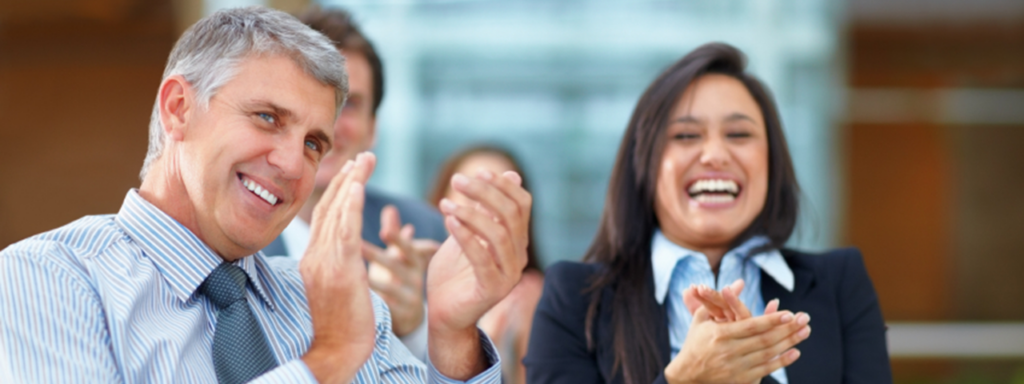 2 people smiling and clapping